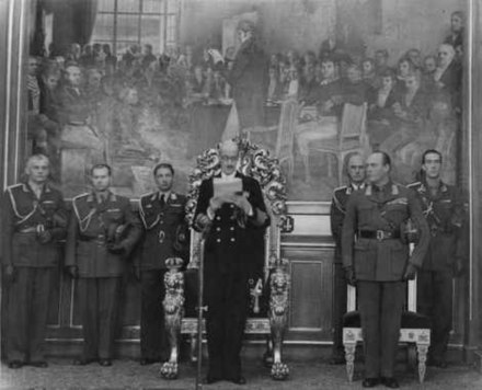 King Haakon VII reading the Speech from the Throne to the Storting in 1950, Crown Prince Olav on his right side