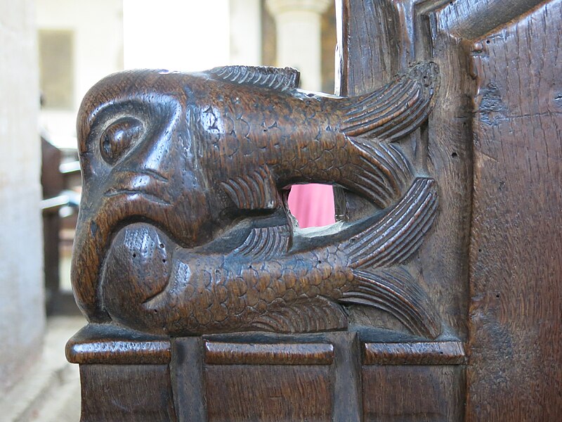 File:Bench-end- One fish swallowing another.jpg