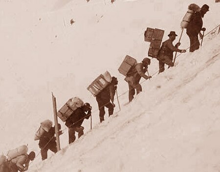 Miners carry gear up the Chilkoot Pass to reach the Klondike