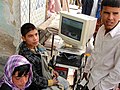 Computer users in a Kabul marketplace, 22 October 2010.jpg