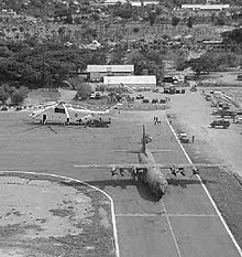 Mil Mi-26 heavy-lift helicopter and Lockheed C-130H Hercules transport at the airport in February 2000 Contract helicopters are parked at the Dili airfield.jpg