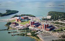 The two existing units of the Olkiluoto Nuclear Power Plant. On the far left is a visualization of a third unit, which, when completed, will become Finland's fifth commercial nuclear reactor. EPR OLK3 TVO fotomont 2 Vogelperspektive.jpg