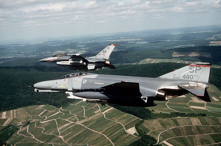 A F-4G Phantom II Wild Weasel from 480th Tactical Fighter Squadron and a F-16C Block 25 Falcon from 52d Tactical Fighter Wing Commander fly over Germany in June 1989