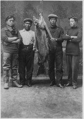 Native American men with large salmon Four unidentified young Indian men with large salmon. - NARA - 297544.tif