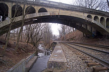 The Montclair-Boonton Line passing under the Freeman Parkway Bridge, with Toney's Brook running parallel. Freeman Parkway, Toney's Brook, and Montclair-Boonton Line.jpg