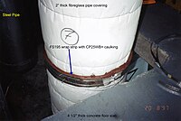 Glass wool pipe insulation covering a steel pipe as it penetrates a mock-up concrete slab whose opening will be firestopped. In this manner, the vapor barrier (in this case made of foil/scrim/kraft paper, called ASJ, all-service jacket, aluminium on the inside, white paper on the outside) can remain intact as it penetrates the fire barrier. Fs195 cp25 fibreglass pc.jpg