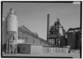 GENERAL VIEW OF FURNACE BUILDING NO. 2 BEHIND CONVEYOR ASSOCIATED WITH BURRELL CONSTRUCTION COMPANY; TO RIGHT IS AMERICAN WINDOW GLASS COMPANY BATCH PLANT, LOOKING SOUTHEAST - HAER PA,65-ARN,1C-1.tif