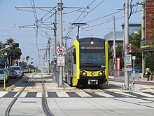 An E Line train of the LA Metro at Downtown Santa Monica station. Gold Line train leaving Downtown Santa Monica station, July 2017.JPG