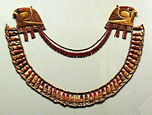 A broad collar with falcon-head terminals from the tomb of Thutmose III's three wives Jewellry from the Wady Gabbanat el-Qurud tomb of Thutmose III's 3 foreign wives.jpg