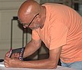 * Nomination Marciano Durán, writer from Uruguay, signing a copy of his book Artigas, cara a cara (Artigas, face to face) in Argentino Hotel of Piriapólis, Uruguay --Ezarate 13:56, 20 January 2023 (UTC) * Promotion Too much (chroma) noise --Poco a poco 15:21, 20 January 2023 (UTC) done, thanks --Ezarate 15:49, 20 January 2023 (UTC) Better, I just saw that there is purple CA, can you please, address that too. With that fixed it's a QI to me --Poco a poco 13:11, 22 January 2023 (UTC) done, thanks --Ezarate 21:50, 23 January 2023 (UTC)  Support Good quality. --Poco a poco 12:29, 24 January 2023 (UTC)