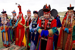 Men and Women in Traditional Mongolian Dress Look on as Secretary Kerry Attends a "Mini-Nadaam" at a Field Outside of Ulaanbaatar (27506837976).jpg