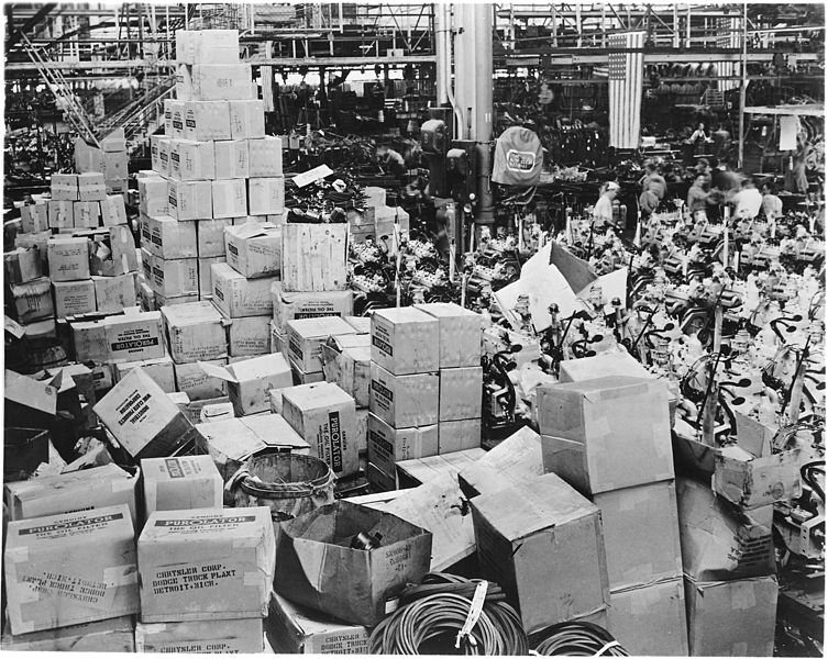 File:Piles nearly to the roof and covering a huge area of floor space is the big stock of accessories for Army truck... - NARA - 196217.jpg