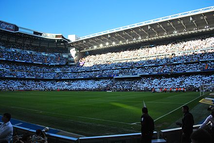 Real Madrid fans displaying the white of their club before El Clásico. Real Madrid fans also often wave Spanish flags at El Clásico games.[229]