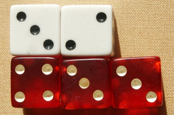 Example of matching up attacking (red) and defending (white) dice; in this dice roll, the defender loses two armies.