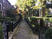 Sidewalk defined on both sides by fencing (24368336698).jpg