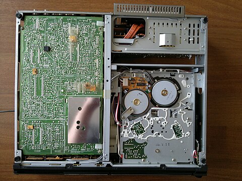 Parts in the interior of the Betamax VCR (bottom): lower main circuit board (left), tape mechanism (right)