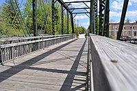 The Ozaukee Interurban Trail goes over Cedar Creek on the interurban bridge, a former railroad truss bridge in downtown Cedarburg.