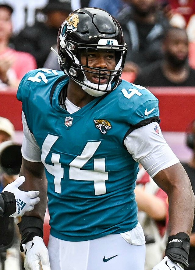 Travon Walker wearing a Jacksonville Jaguars helmet and uniform.