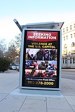 An FBI bus stop sign in Washington seeking information for violence at the Capitol Tuesday afternoon, 12 January 2021 Walk from US Capitol West to Union Station - Washington DC IMG 0547 (50840572217).jpg