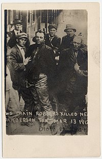 Photograph shows the bodies of Ben Kilpatrick and Ole Hobek being held up by others after being killed near Sanderson Texas, March 13, 1912 Two train robbers killed near Sanderson Tex., Mar. 13, 1912 LCCN2006680243.jpg