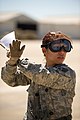 U.S. Air Force Staff Sgt. Rosemery Aragon, an aeromedical service superintendent with the 43rd Aeromedical Evacuation Squadron, signals as Airmen load simulated patients during Joint Readiness Training Center 140313-F-RW714-140.jpg