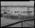 View of east end of south elevation of Building No. 34. Looking northwest - Easter Hill Village, Building No. 34, East side of Corto Square, Richmond, Contra Costa County, CA HABS CA-2783-AA-6.tif