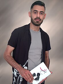 Rakan Daqar with his book Madness of Love in 2021