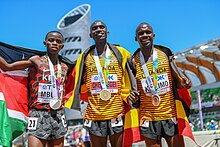 Cheptegei (C) with his gold for the 10,000 m at the 2022 World Athletics Championships in Eugene. 10000m men medallists Oregon 2022.jpg