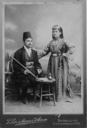 Sephardi Jewish couple from Sarajevo in traditional clothing. Photo taken in 1900. 1900 photo of a Sephardi couple from Sarajevo.png