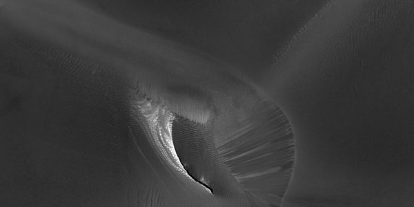 Close view of white spot among the dark dunes showing ripples and streaks