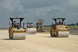 Heavy equipment operators from the 820th RED HORSE Squadron operate vibratory rollers to compact material under the runway at Seguin Auxiliary Airfield, Joint Base San Antonio, Texas, 2014 820th Red Horse Squadron 140623-F-IJ798-116.jpg