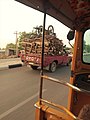 A Mini Van transporting Logs of Woods.jpg
