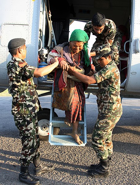 File:A rescued old woman being assisted by the Nepalese Armed Forces Personnel while alighting from a Mi-17 helicopter.jpg