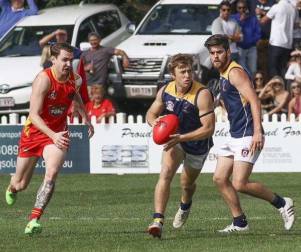 Defensive player giving chase to an attacking player with the ball