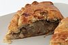 Cornish pasty, cut open (though usually eaten with fingers, by holding the thick crust). Traditional filling shown.