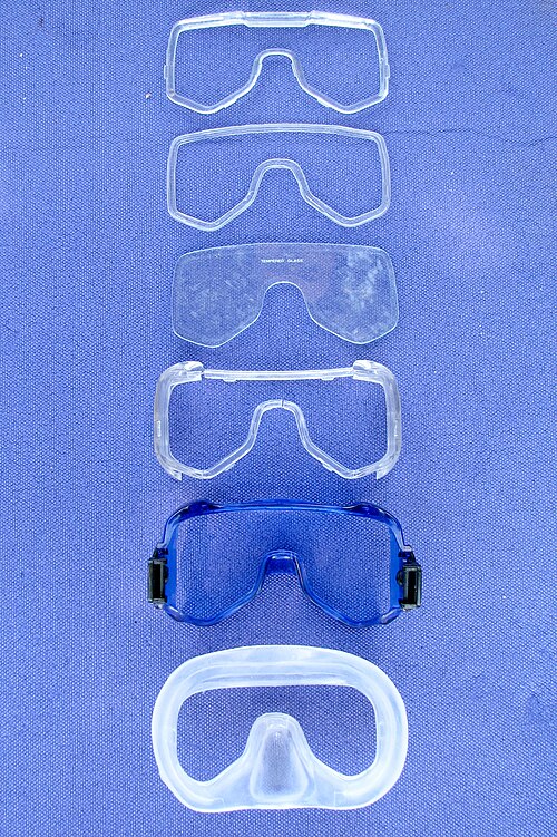 Disassembled components of a single-window, low-volume dive mask