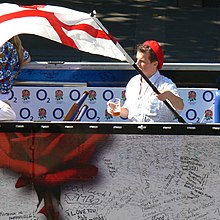 English Rugby team supporter waving the English flag in the streets of Nantes, France in 2007 English fan - RWC 2007.jpg