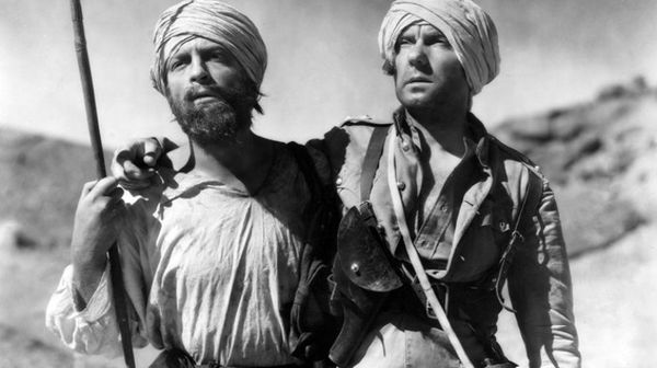 Faversham (left) guiding the blind Durrance through the desert to safety
