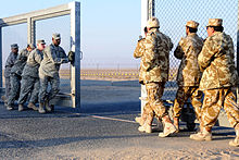 US and Kuwaiti troops closing the gate between Kuwait and Iraq on 18 December 2011 Gate closing Iraq-Kuwait border.jpg