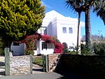 This impressive dwelling, which was erected during the first decade of the twentieth century by Hugo Naude, the well-known artist, as home and studio, is predominantly in the neo-Classical idiom. He lived here until his death on 5 April 1941. In particular Type of site: House Current use: House. Hugo Naude House, 115 Russell Street, Worcester, South Africa.jpg