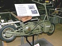 Складной мопед, применявшийся британскими парашютистами во время ВМВ. Мопед собирался и заводился за 15 с (вес 32 кг, скорость до 50 км/ч.