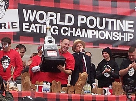 Joey Chestnut holds the trophy at the 2012 World Poutine Eating Championship in Toronto.