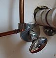 Kitchen renovation replacing valve beneath sink with two compression fitting pipes detached.JPG