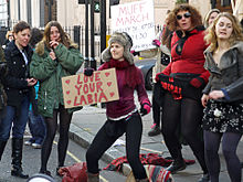 A woman holding a sign saying "Love your labia" at the Muff March in London, 2011 Muff March Harley Street 5.jpg