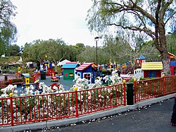 Old-fashioned roses line the walkways by a Lego toddler play area called Duplo Playtown.jpg