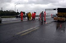 People in safety vests reroute traffic