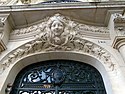 Art Nouveau mascaron above a door in Paris