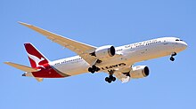 A red triangle containing a white silhouette of a kangaroo, with the word Qantas next to the triangle.