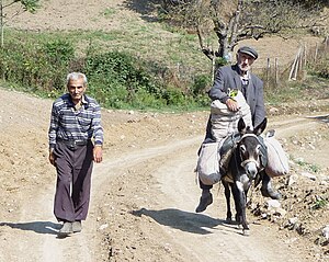 Men on a dusty road in NKR Starci, Nahorni Karabach.jpg