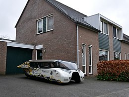 Stella Lux, a solar-powered family car in front of a house.jpg